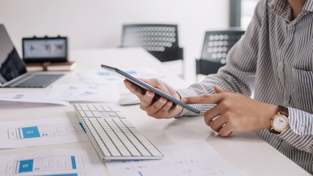 Business man using a touchpad to view his e-mails on his desk at the office.